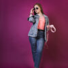 a woman wearing sunglasses and holding headphones